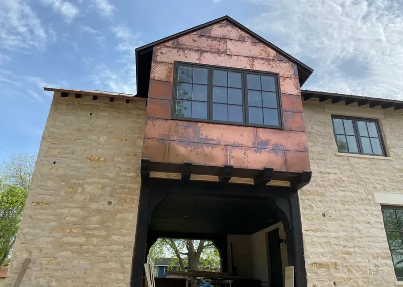 Copper metal panel facade on a stone building for Skylight Installation in Des Peres