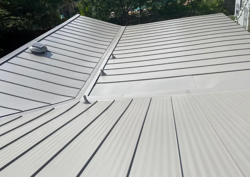 Solar attic fan installed on a metal roof for Roof Ventilation in Des Peres
